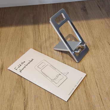Soporte Plegable de Aluminio para Celular y Tablet con Abre Botellas